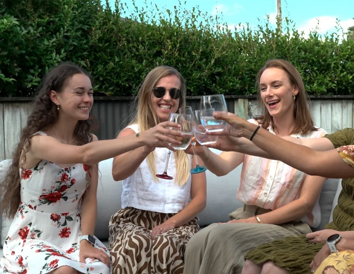 Friends celebrating together with drinks